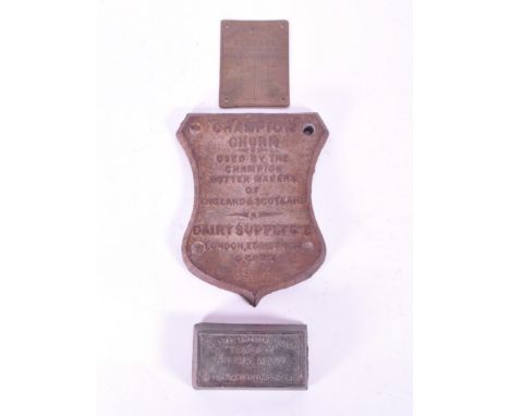 Three late 19th / early 20th century metal plaques, comprised of a Champion Churn Dairy Supply Co Ltd cast iron plaque, The E