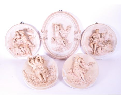 A collection of five bisque pottery Parian ware wall plaques depicting courting couples and classical figures in relief. Larg