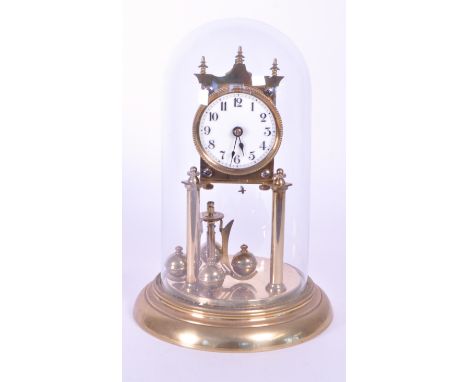 20th century German brass anniversary mantel clock in glass dome raised on a circular brass plinth style base. White enamel c