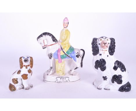 A collection of three 19th century Staffordshire ceramic figures. The collection to include two spaniel dog figures, alongsid