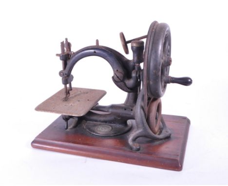 Willcox &amp; Gibbs - An early 20th century Willcox &amp; Gibbs hand crank sewing machine. The machine on a mahogany base. Ha
