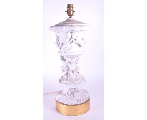 20th century bisque porcelain classical cherub table lamp raised on a cylindrical brass base with converted light fixture ato