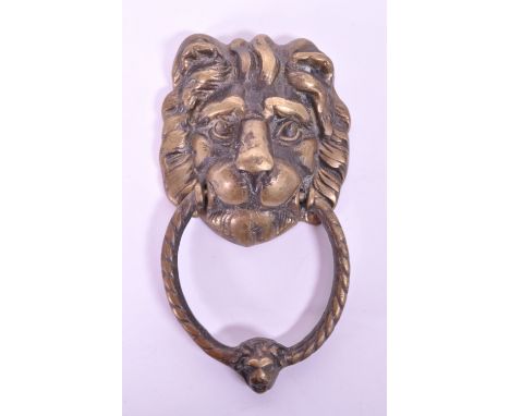 A 19th century Victorian lion brass door knocker. Featuring a lion's head with ring knocker with another smaller lion bust.20