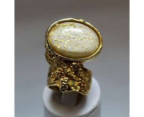 Yves Saint Laurent "Arty" cocktail ring in gilt metal with mottled white and gold oval cabochon, size R½, with satin pouch an