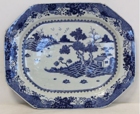 18th century Chinese Export blue and white octagonal ashet or meat platter with landscape panel of cottages by a lake surroun