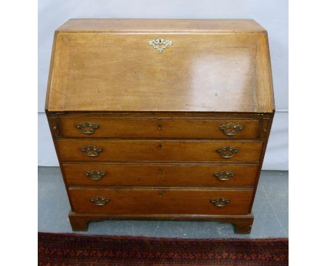 19th century oak bureau, the fall front revealing fitted interior over four graduated drawers on bracket feet, 92cm