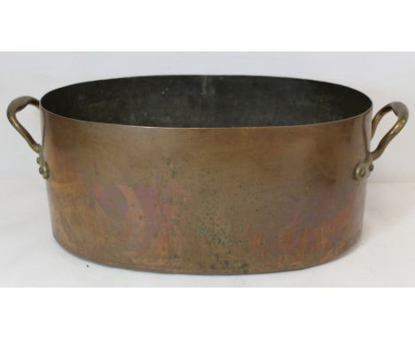 Large 19th century twin handled copper pan of oval form fitted with metal liner for use as a jardinere or planter, both handl