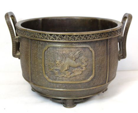 Chinese Qing dynasty patinated bronze censer or jardinere of twin handled lobed circular form with two panels of a dragon and