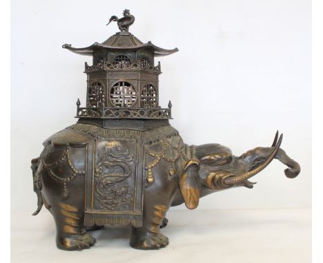 Chinese Qing dynasty large bronze censer in the form of an elephant with pierced pagoda howdah top and phoenix finial, unmark