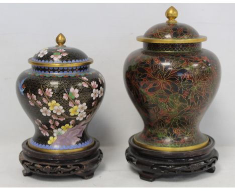 20th century Chinese cloisonné covered jar of baluster form decorated with flowering prunus, bird and magnolia sprig, on blac