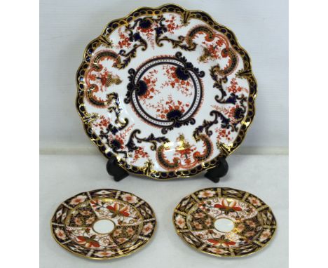 Royal Crown Derby plate with frilled rim decorated in the Imari palette, 23cm diam. and two small saucers, both pattern no. 2