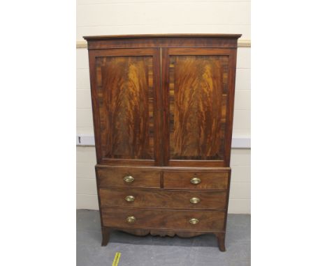 19th century mahogany linen press, the upper section enclosed by two cross banded doors, the chest below fitted with two shor
