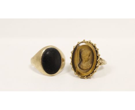 9ct gold signet ring with intaglio 'tigers eye' portrait and another with onyx. (2).&nbsp;