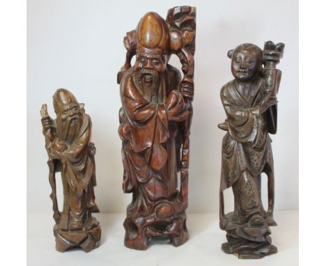 Two Chinese carved hardwood figures of the deity Shou Lao, the larger drilled as a lamp base, 39.5cm high, the smaller, 26.5c