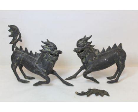 Pair of Chinese bronze figures of Kylin, 20cm high, one with detached tail.