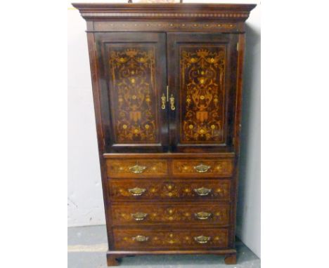 Inlaid mahogany linen press, c. 1890/1900, enclosed by pair of panel doors with winged head, crowns, lyre and swag decoration