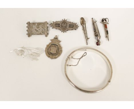 Silver brooch modelled as a gate, five others, a silver medal and a bangle.