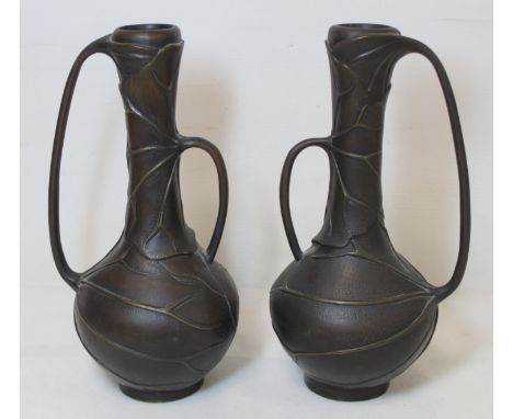 Pair of Japanese Meiji period bronze vases of globe and shaft form with moulded lotus leaf decoration and twin asymmetric sle