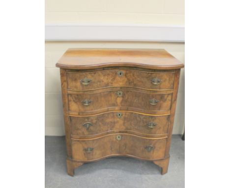 Walnut serpentine form chest of four drawers on bracket feet. 77cm