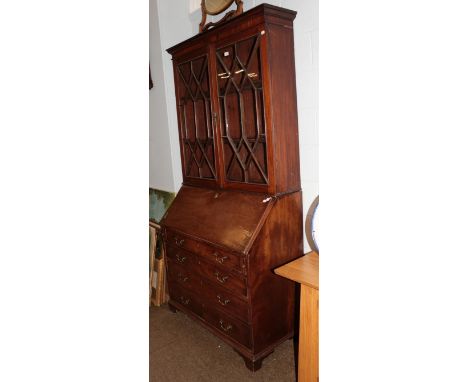 A George III mahogany bureau bookcase, the upper section with glazed astragal doors enclosing two adjustable shelves above a 