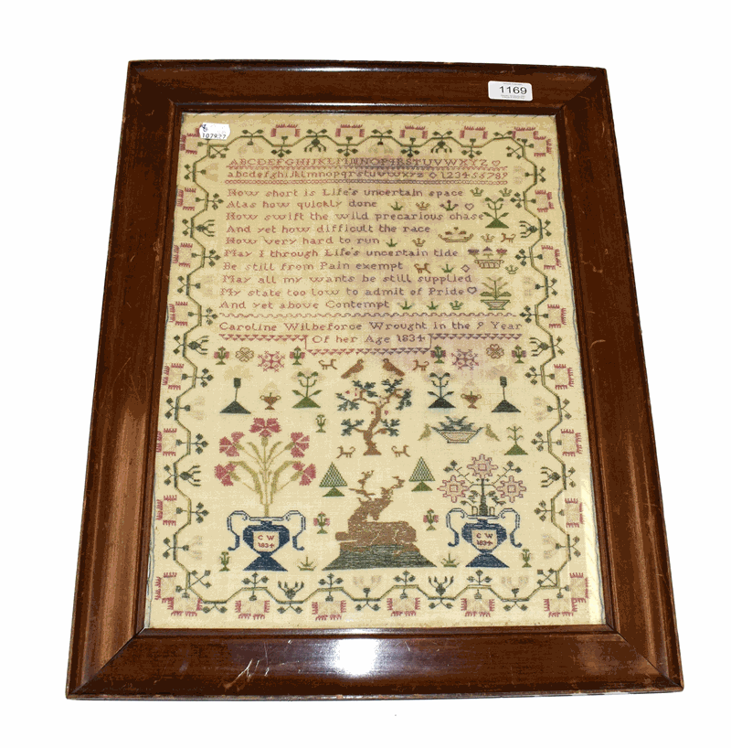 An alphabet sampler worked by Caroline Wilberforce Aged 9, Dated 1834, alphabet and verse worked in pink silk threads, decora