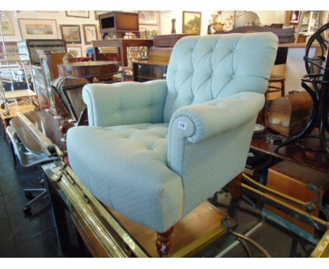 A light blue button back armchair