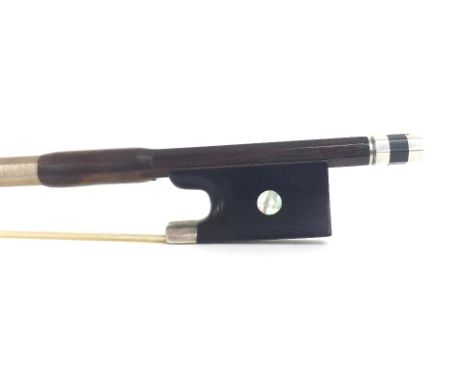 German silver mounted violin bow, unstamped, the stick octagonal, the ebony frog inlaid with pearl eyes and the ebony adjuste