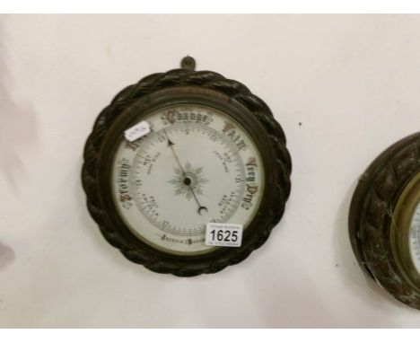 An oak rope edge barometer with porcelain face