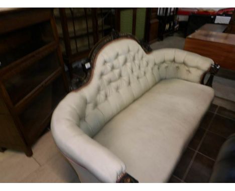 A Victorian ebonised wood framed sofa