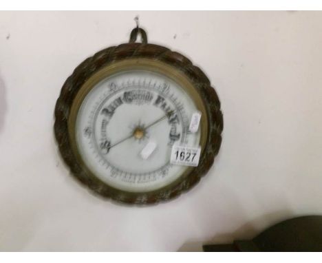 An oak rope edge barometer with porcelain face