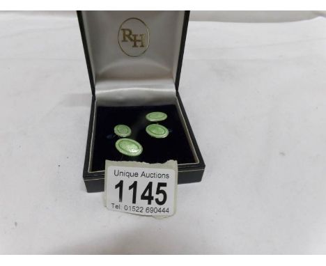 A pair of silver and enamel cuff links