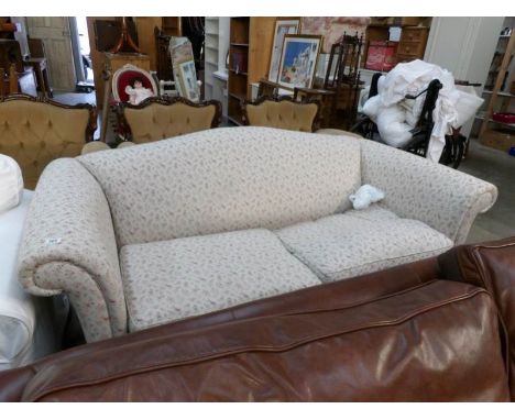 A floral Chesterfield style sofa