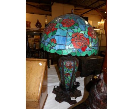 A large table lamp with Tiffany style base and shade