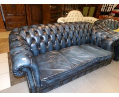 A blue leather Chesterfield sofa