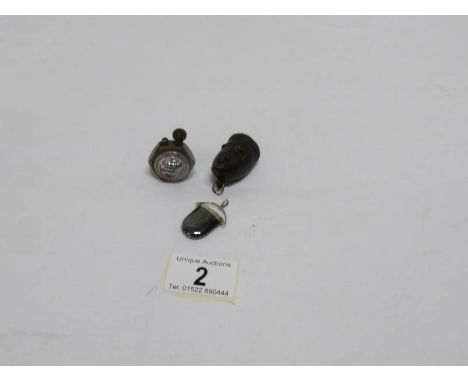 A Naval 'button' lighter, a carved head and a silver pendant