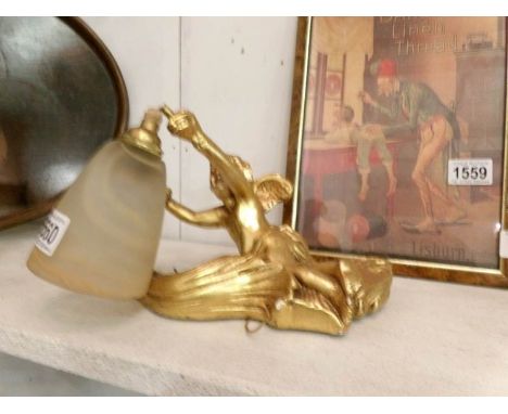 A gilded cherub wall light with shade