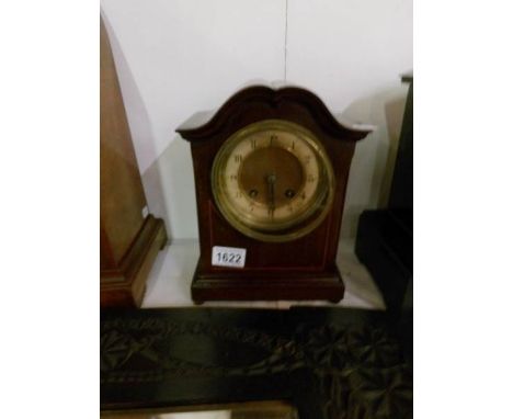 A mahogany inlaid mantel clock