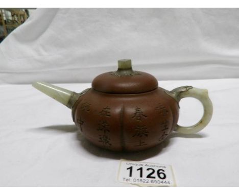 A Chinese Yixing pottery teapot with jade handle, spout and lid knob