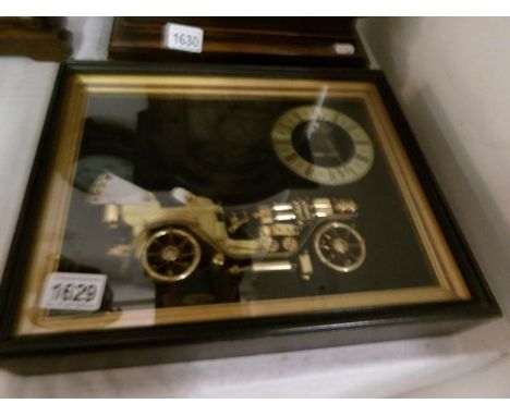 A framed clock made from machine parts