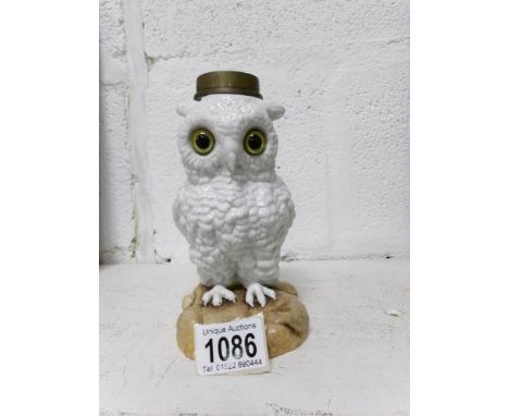 A 19th century novelty porcelain oil lamp base in the shape of an white owl with glass eyes