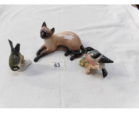 A Royal Doulton Siamese cat, A Beswick Bullfinch and a Goebel bluetit