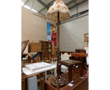 An oak standard lamp with shade
