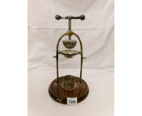 A silver plated hotel lemon squeezer with continental silver 800 glass coaster