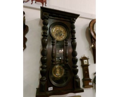 A Victorian wall clock with figure of eight door
