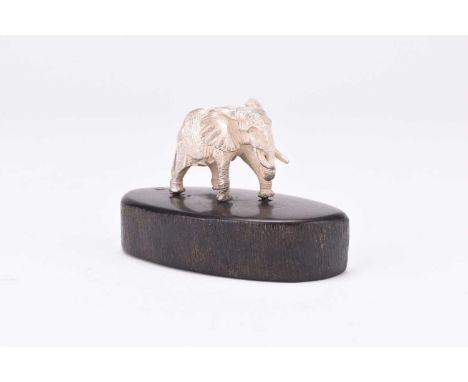 A Patrick Mavros silver model of an elephant, presented upon wood base, 4cm high