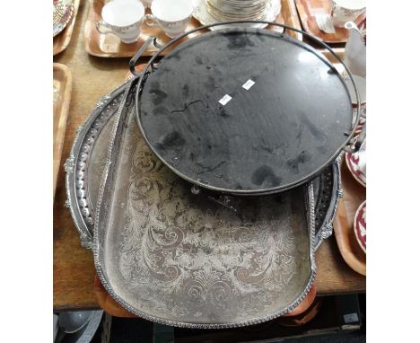 Three metal trays; one glass with metal rim and handles and two silver plate with etched designs. (3)(B.P. 21% + VAT) 