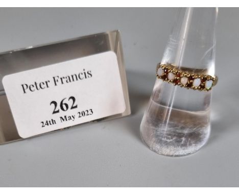 9ct gold opal and red stone dress ring.  1.7g approx.  Ring size O 1/2.     (B.P. 21% + VAT) 