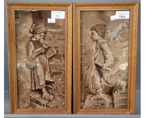 Pair of framed ceramic tiles depicting children on their way to school. 29x14cm approx. Oak frames. (2) (B.P. 21% + VAT)  Bot
