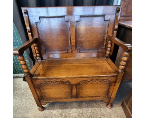 Early 20th century oak Monk's bench /hall seat with tip over top and lift seat on bobbin supports. (B.P. 21% + VAT)  91x46x92