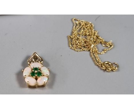 Fine yellow metal chain together with a 9ct gold opal and emerald flowerhead pendant.  Total weight 2.3g approx.     (B.P. 21